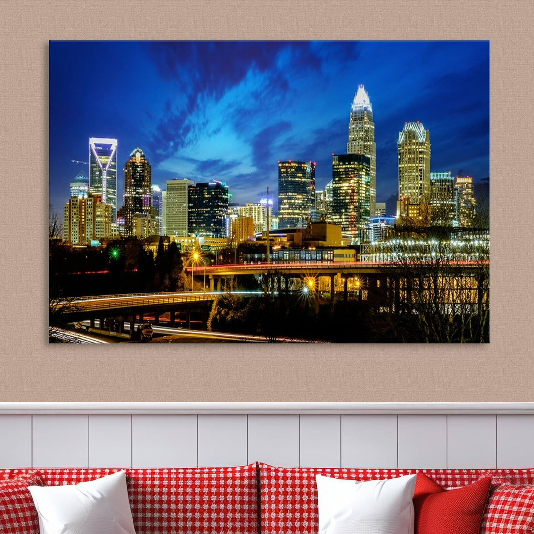 A modern living room highlighted by the "Charlotte City Lights Cloudy Blue Night Skyline Cityscape View" wall art canvas print, crafted on museum-quality canvas with UV-protective coating.