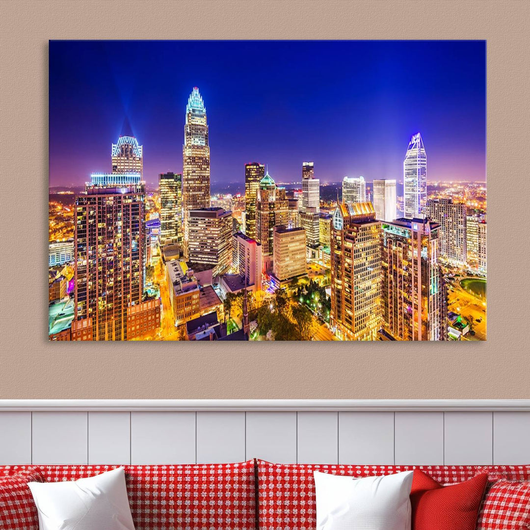 A modern living room features the Charlotte City Lights Night Blue Skyline Cityscape View wall art canvas print.