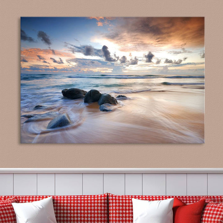 The "Serene Weather On The Beach Wall Art Canvas Print," featuring a tranquil beach scene with rocks and waves, is ready to hang and enjoy.