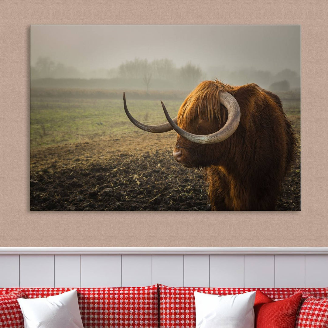 The "Big Cow Horn Wall Art Canvas Print" is a hand-assembled framed canvas depicting a Highland cow in a misty field. It is crafted with a UV-protective coating to ensure lasting vibrancy.