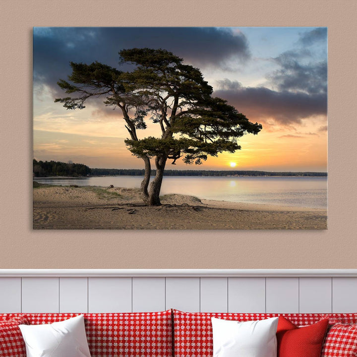 The room showcases the Coastal Sunset Wall Art Canvas Print, a triptych elegantly displayed on museum-quality polycotton canvas, depicting a serene beach sunset with a tree.