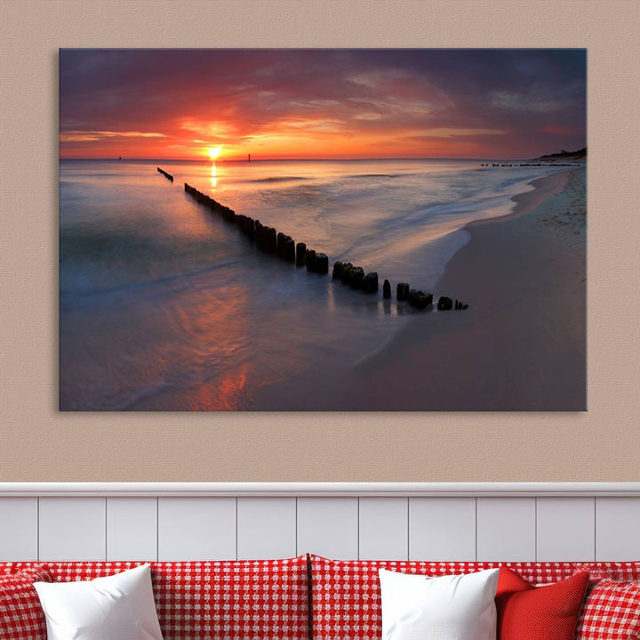 In a modern living room, the Sunset Beach Wall Art Canvas Print is displayed above. This triptych, printed on museum-quality canvas with a UV-protective coating, ensures lasting brilliance. It's ready to hang and brings an elegant touch to your space.