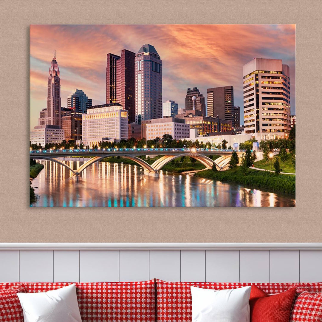 The "Columbus City Lights Sunset Orange Cloudy Skyline Cityscape View" wall art is featured on the wall. This triptych is printed on museum-quality canvas and includes a UV-protective coating, ensuring lasting vibrancy.