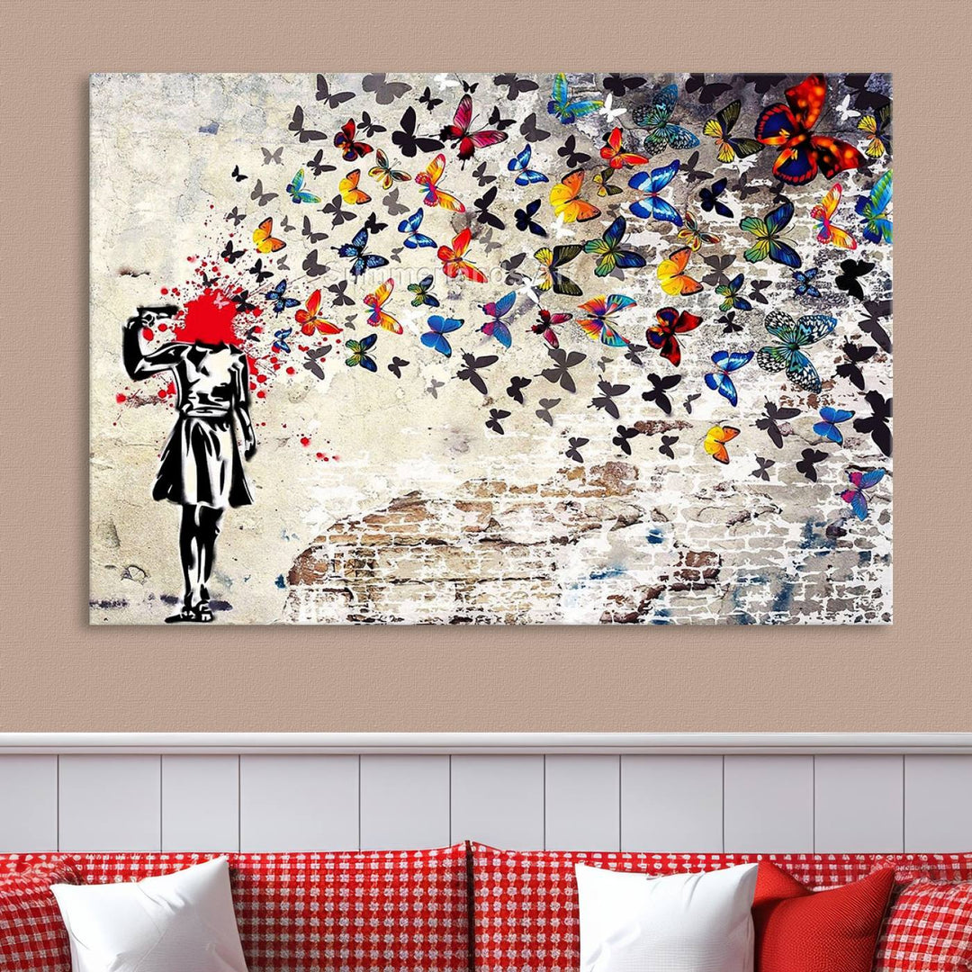 The Banksy Art Butterfly Girl Explosion Canvas showcases a dynamic figure with butterflies bursting from their head, set against a textured wall background. This vibrant urban graffiti piece is perfect for modern interiors and comes ready to hang.