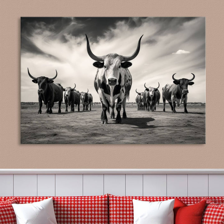 The Black and White Longhorn Cattle Wall Art, featuring a three-panel display of cowboy Western longhorns walking toward the viewer, enhances your space with its striking presence, adding a touch of Western decor.