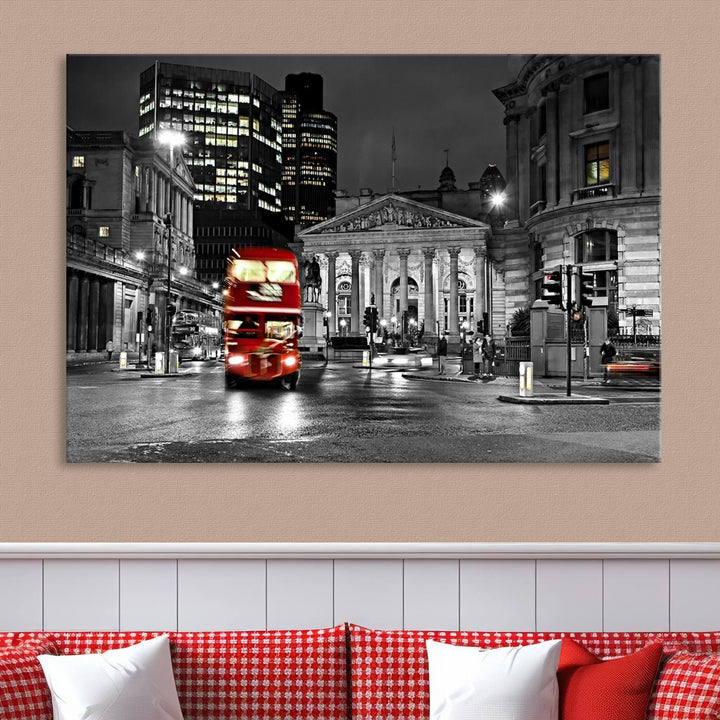 The London Night Red Bus Wall Art Canvas Print features a black and white cityscape with a moving red double-decker bus, crafted on museum-quality canvas with a UV-protective coating. This ready-to-hang artwork is designed to stand out and enhance any space.