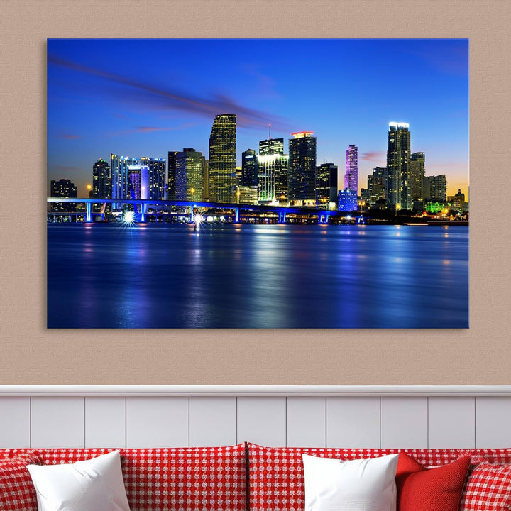 The modern living room showcases a striking Miami Blue Night Wall Art canvas print on the wall. The artwork is gallery wrapped on museum-quality canvas, ensuring durability and elegance.