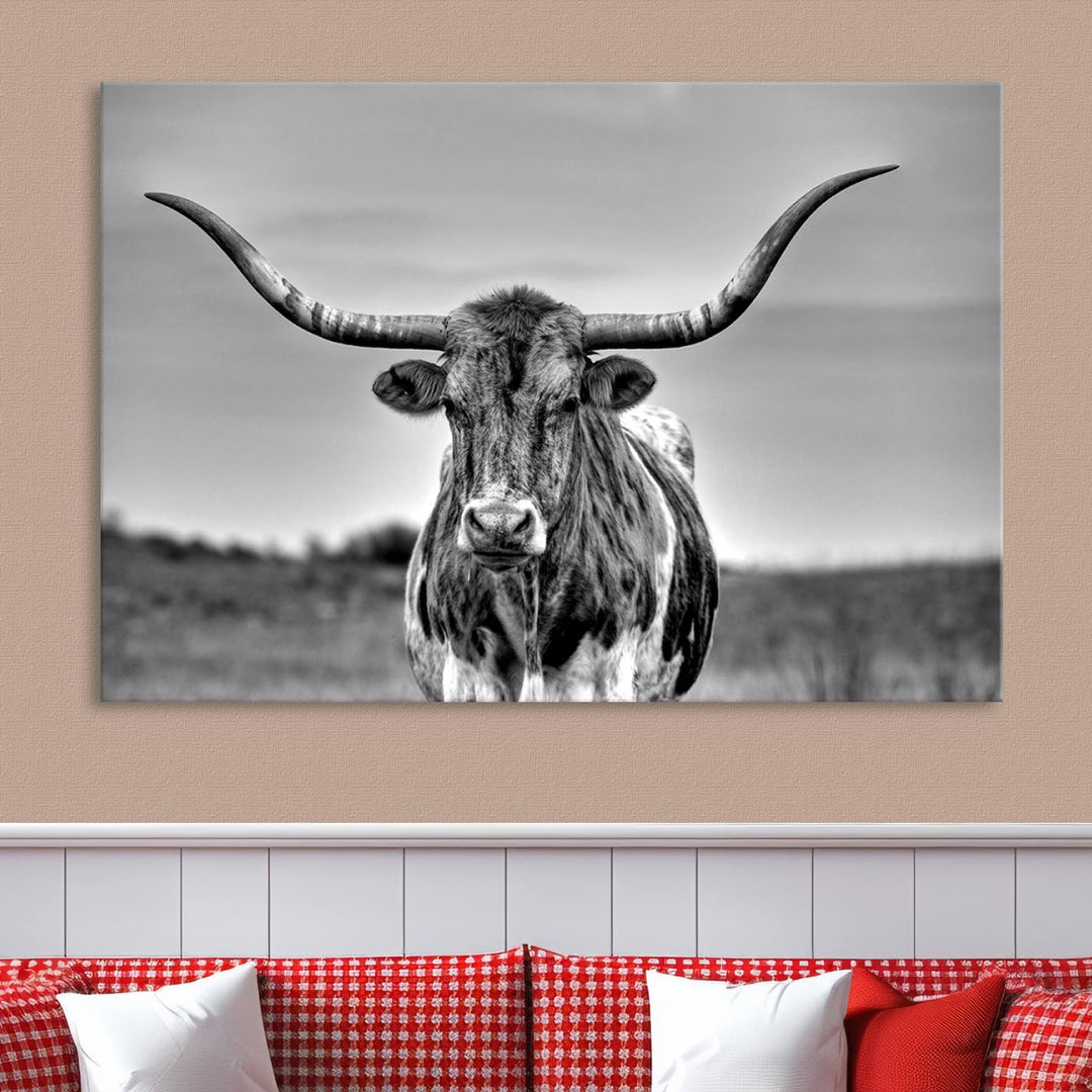 The Texas Longhorn Cow Wall Art, featuring a black and white image of a longhorn bull on canvas, brings charm to the room with its sophisticated appeal.