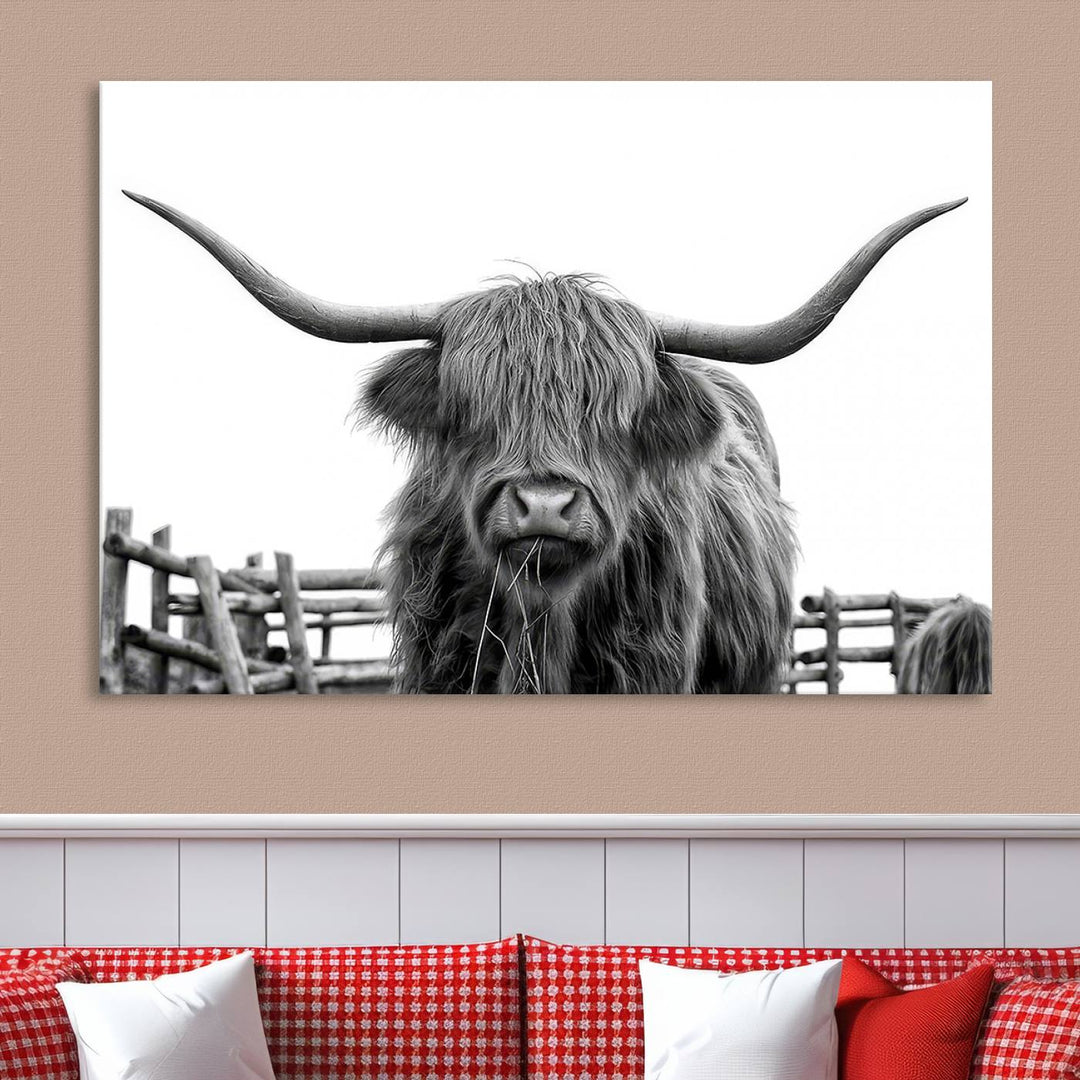 The Longhorn Canvas Print, featuring a black-and-white triptych of a Bighorn cow with shaggy fur and impressive long horns, is elegantly showcased. This wall art piece boasts a gallery-quality finish on premium canvas, bringing sophistication to any room.