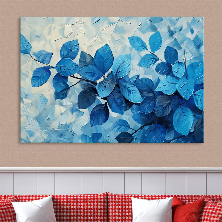 The contemporary living room is highlighted by the Abstract Blue Leaf Wall Art Canvas Print on the wall. The hand-assembled framed art enhances the room's vibrant decor, crafting a gallery-worthy ambience.