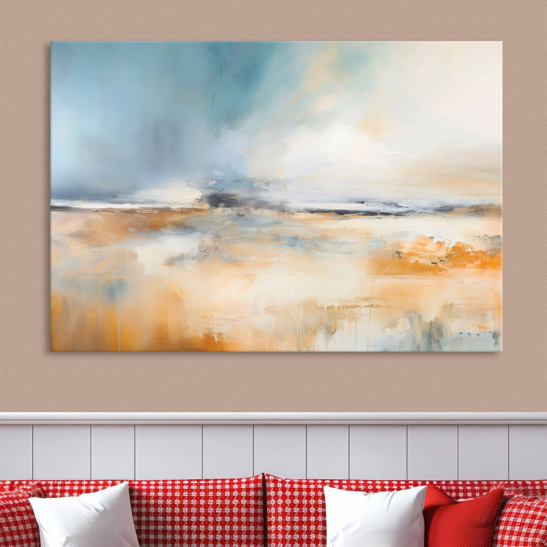 The Abstract Landscape Wall Art Canvas Print, featuring warm tones of orange and blue, is displayed on a dark wall.