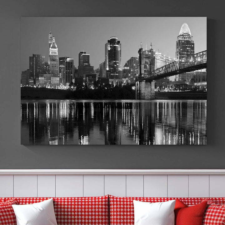 The wall showcases a ready-to-hang triptych of the Cincinnati City Lights Skyline in black and white, printed on museum-quality canvas.