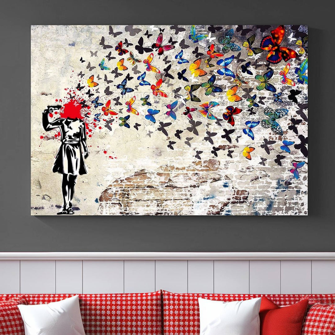 The Banksy Art Butterfly Girl Explosion Canvas showcases a dynamic figure with butterflies bursting from their head, set against a textured wall background. This vibrant urban graffiti piece is perfect for modern interiors and comes ready to hang.