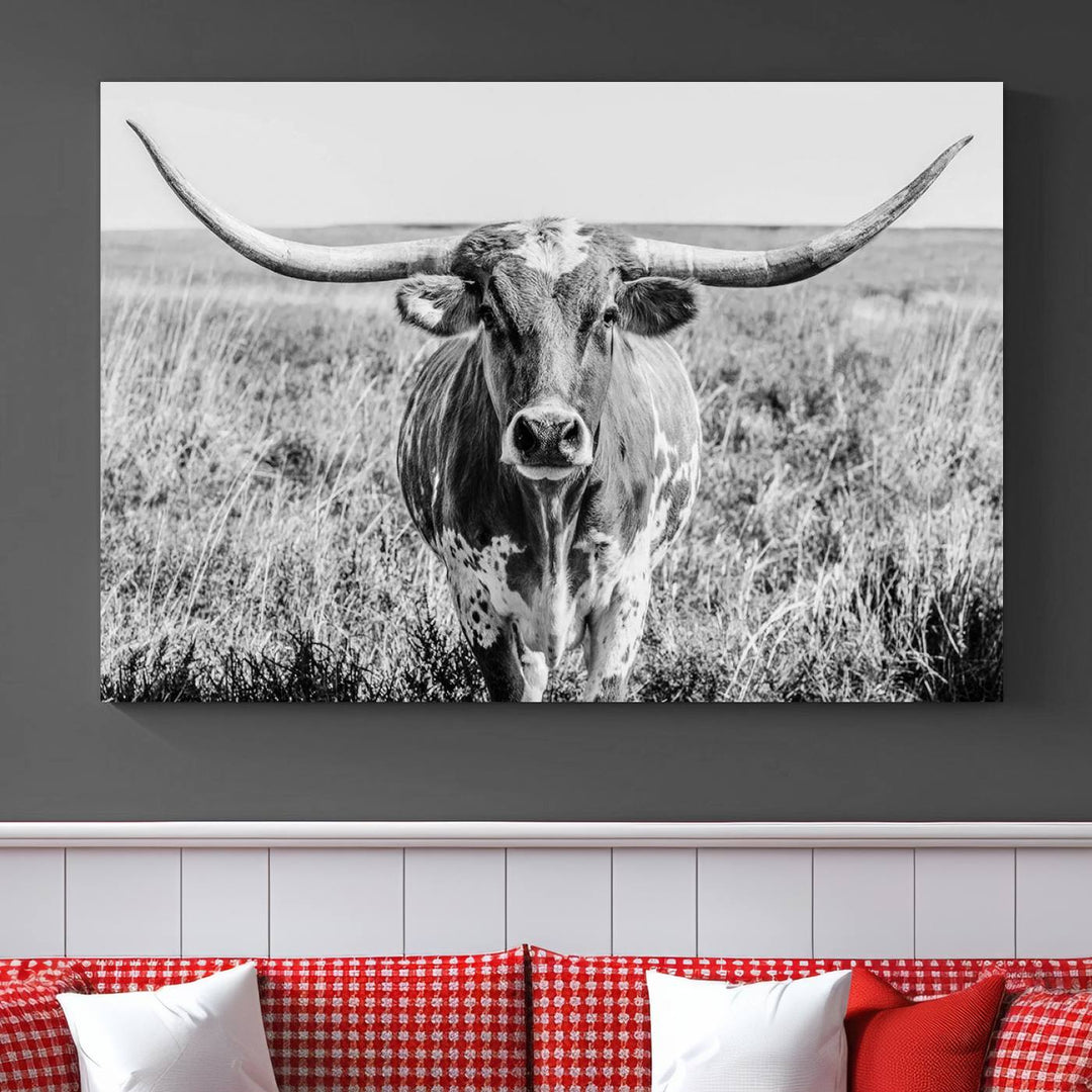 The Texas Cow Longhorn Wall Art Canvas Print is a black and white triptych depicting a cow in a field. It is crafted with museum-quality canvas and features a UV-protective coating.