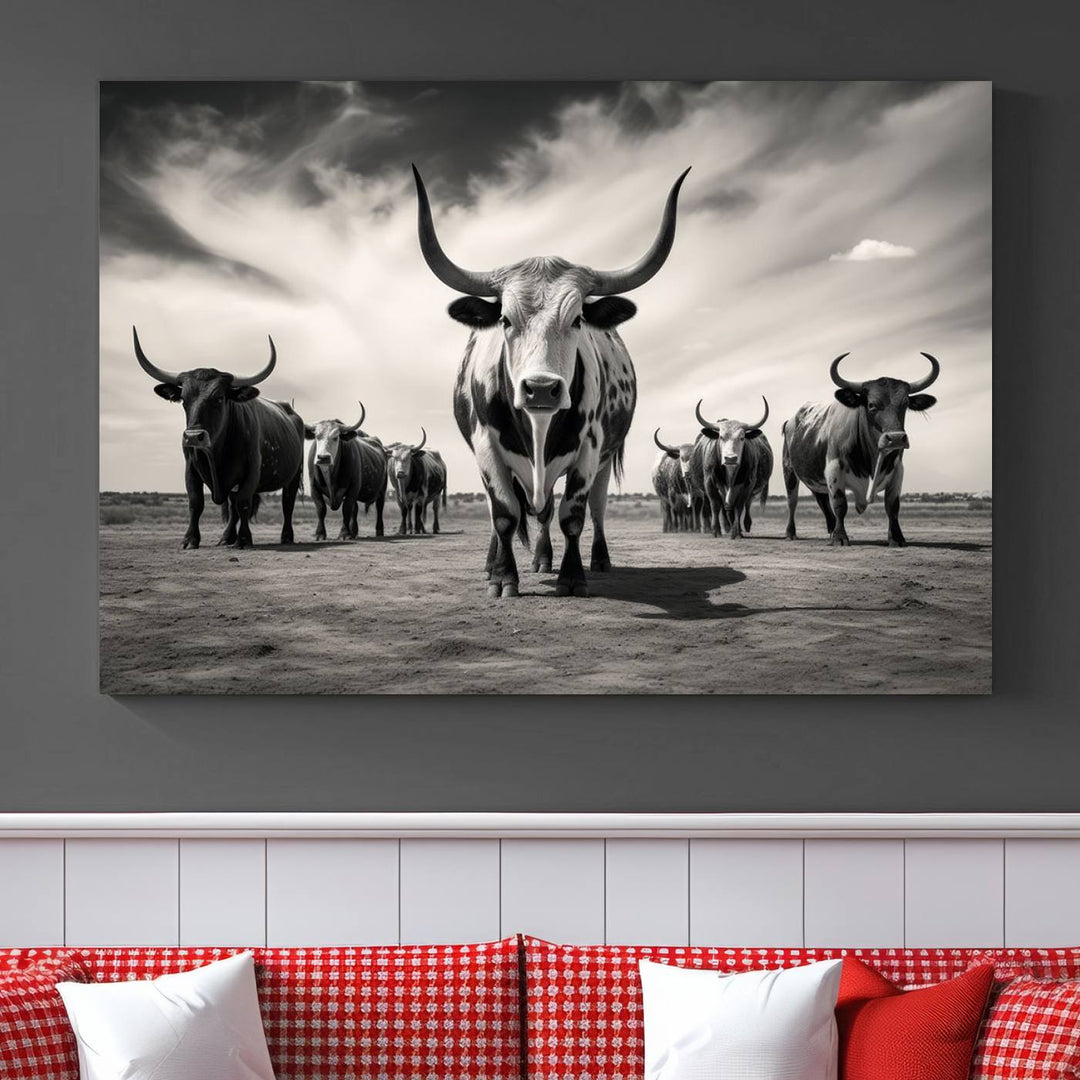 The Black and White Longhorn Cattle Wall Art, featuring a three-panel display of cowboy Western longhorns walking toward the viewer, enhances your space with its striking presence, adding a touch of Western decor.