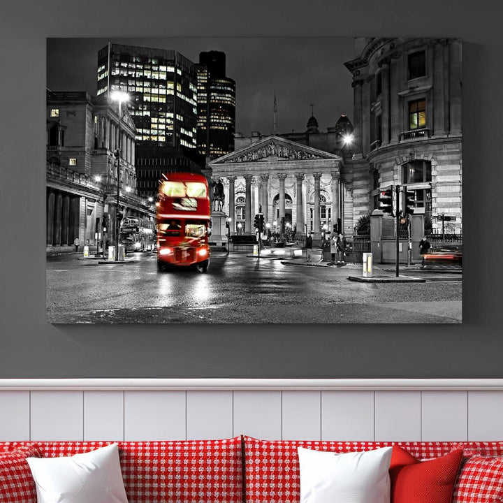 The London Night Red Bus Wall Art Canvas Print features a black and white cityscape with a moving red double-decker bus, crafted on museum-quality canvas with a UV-protective coating. This ready-to-hang artwork is designed to stand out and enhance any space.