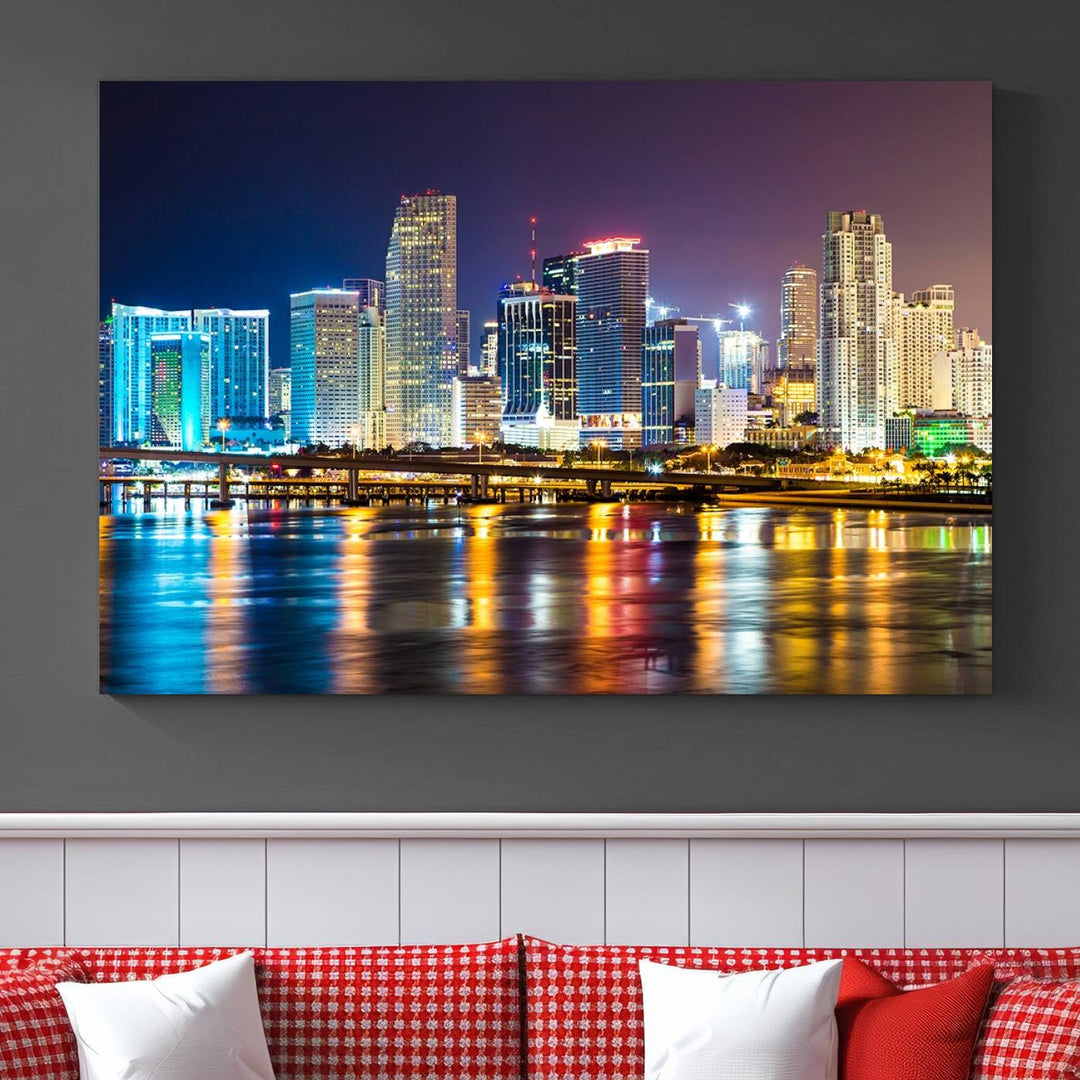 A stunning Miami City Wall Art Canvas Print on museum-quality canvas depicts a vibrant cityscape at night with colorful reflections.