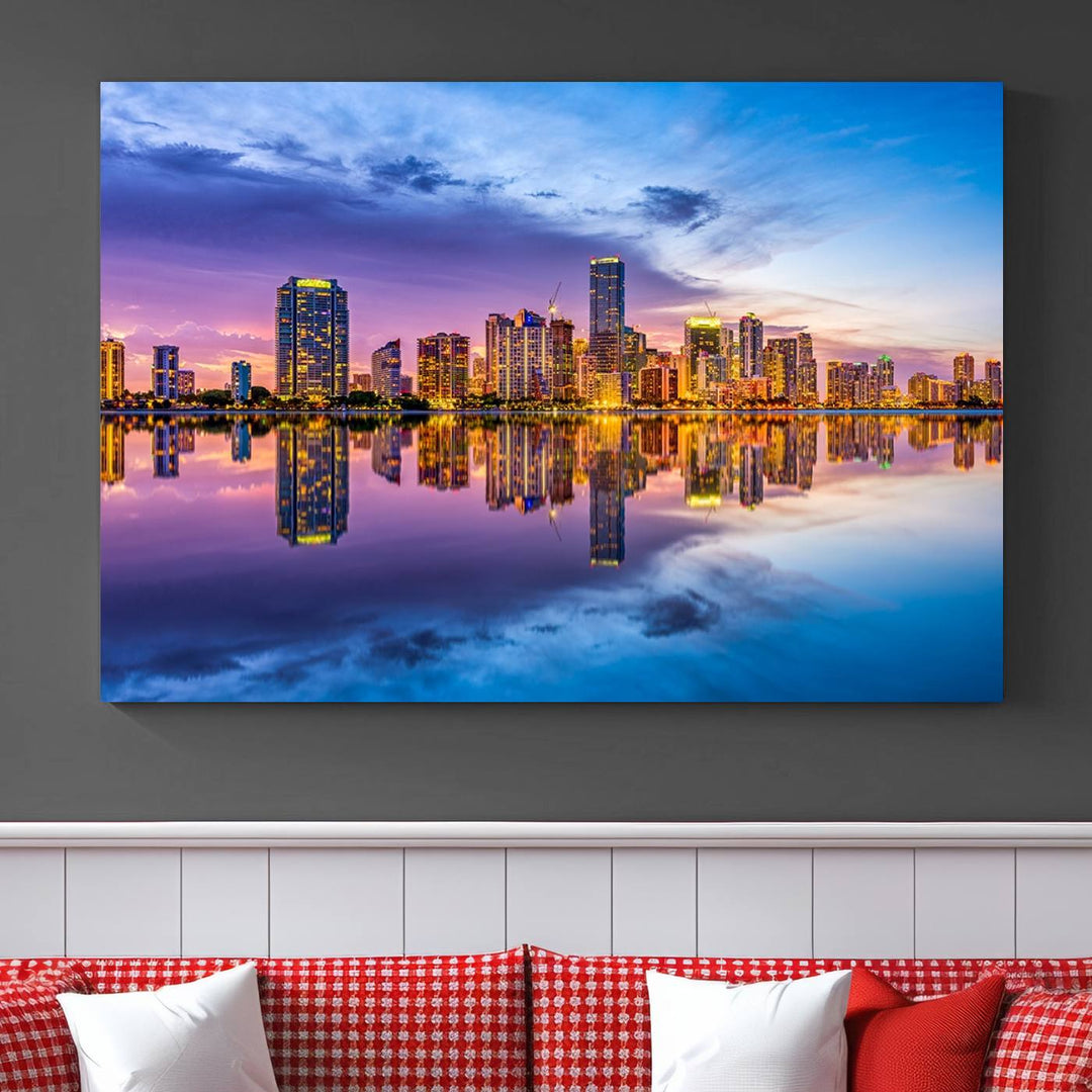 The Miami City Wall Art Canvas Print, featuring a three-panel depiction of a city skyline at sunset reflected in water, beautifully enhances the wall. Made with museum-quality canvas and a UV-protective coating, it comes ready to hang.