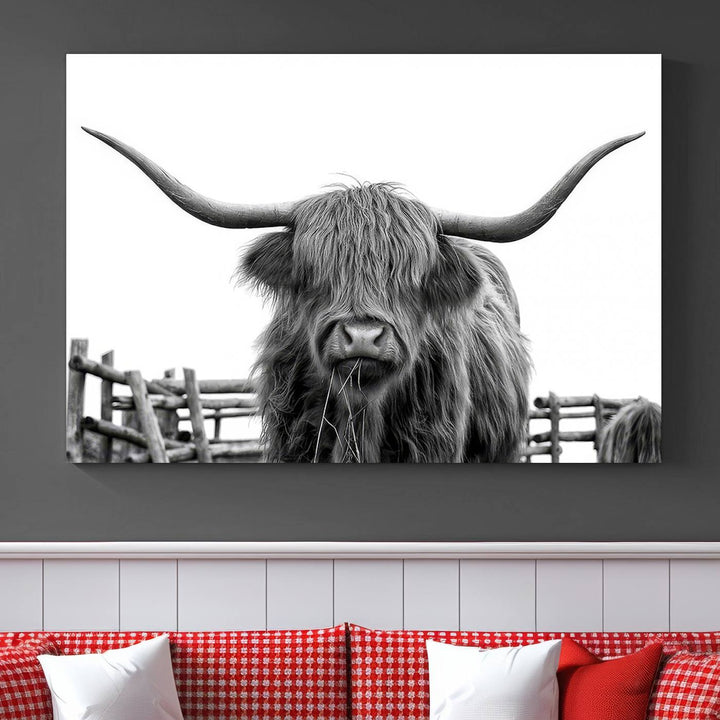 The Longhorn Canvas Print, featuring a black-and-white triptych of a Bighorn cow with shaggy fur and impressive long horns, is elegantly showcased. This wall art piece boasts a gallery-quality finish on premium canvas, bringing sophistication to any room.