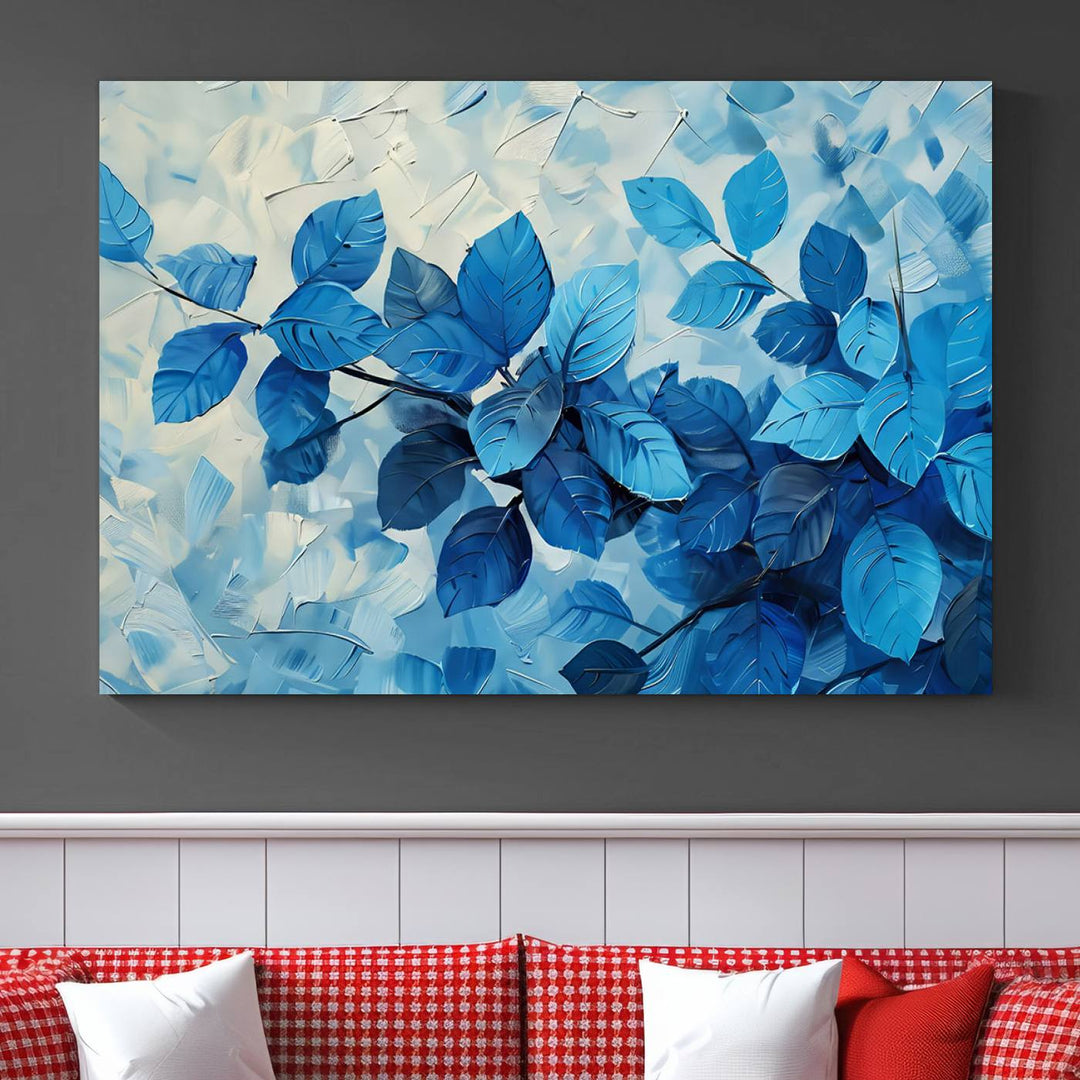 The contemporary living room is highlighted by the Abstract Blue Leaf Wall Art Canvas Print on the wall. The hand-assembled framed art enhances the room's vibrant decor, crafting a gallery-worthy ambience.