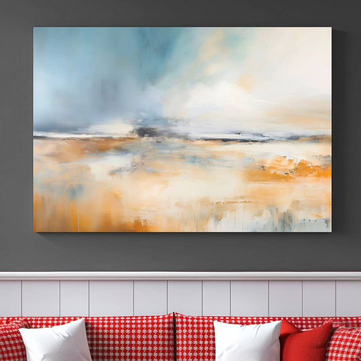 The Abstract Landscape Wall Art Canvas Print, featuring warm tones of orange and blue, is displayed on a dark wall.