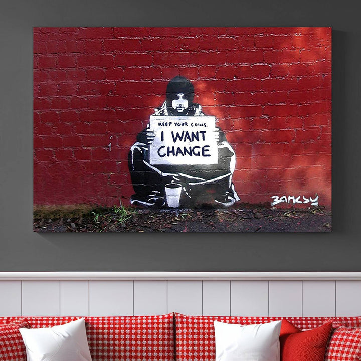 The living room showcases a triptych of stencil artwork on museum-quality canvas, featuring the Banksy I Want Change Graffiti Abstract Wall Art Canvas Print. This captivating piece depicts a person holding a sign that says "I want change" and is finished with a UV-protective coating to ensure long-lasting beauty.