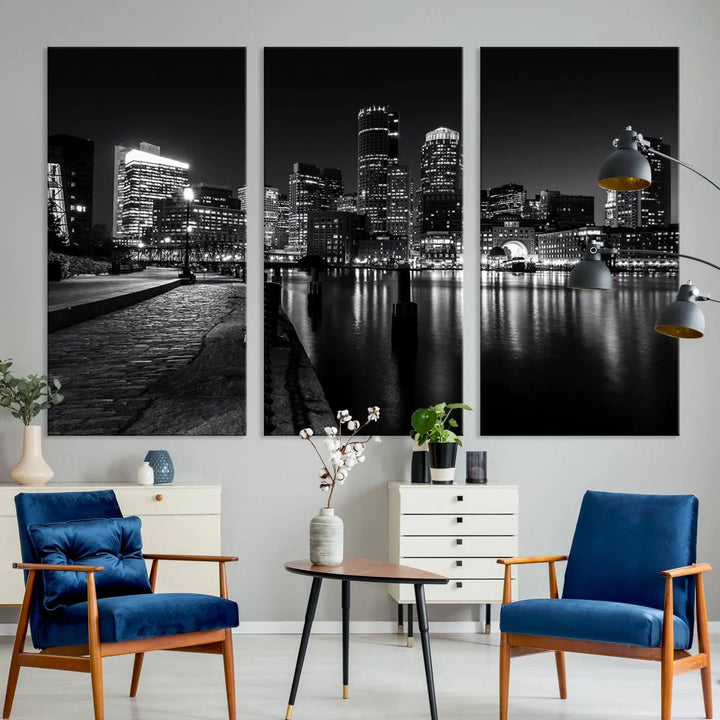 The Boston City Lights Skyline Black and White Wall Art Cityscape Canvas Print portrays a triptych of the city skyline at night reflecting on a calm river. This museum-quality canvas features UV-protective finishes to preserve its timeless allure.