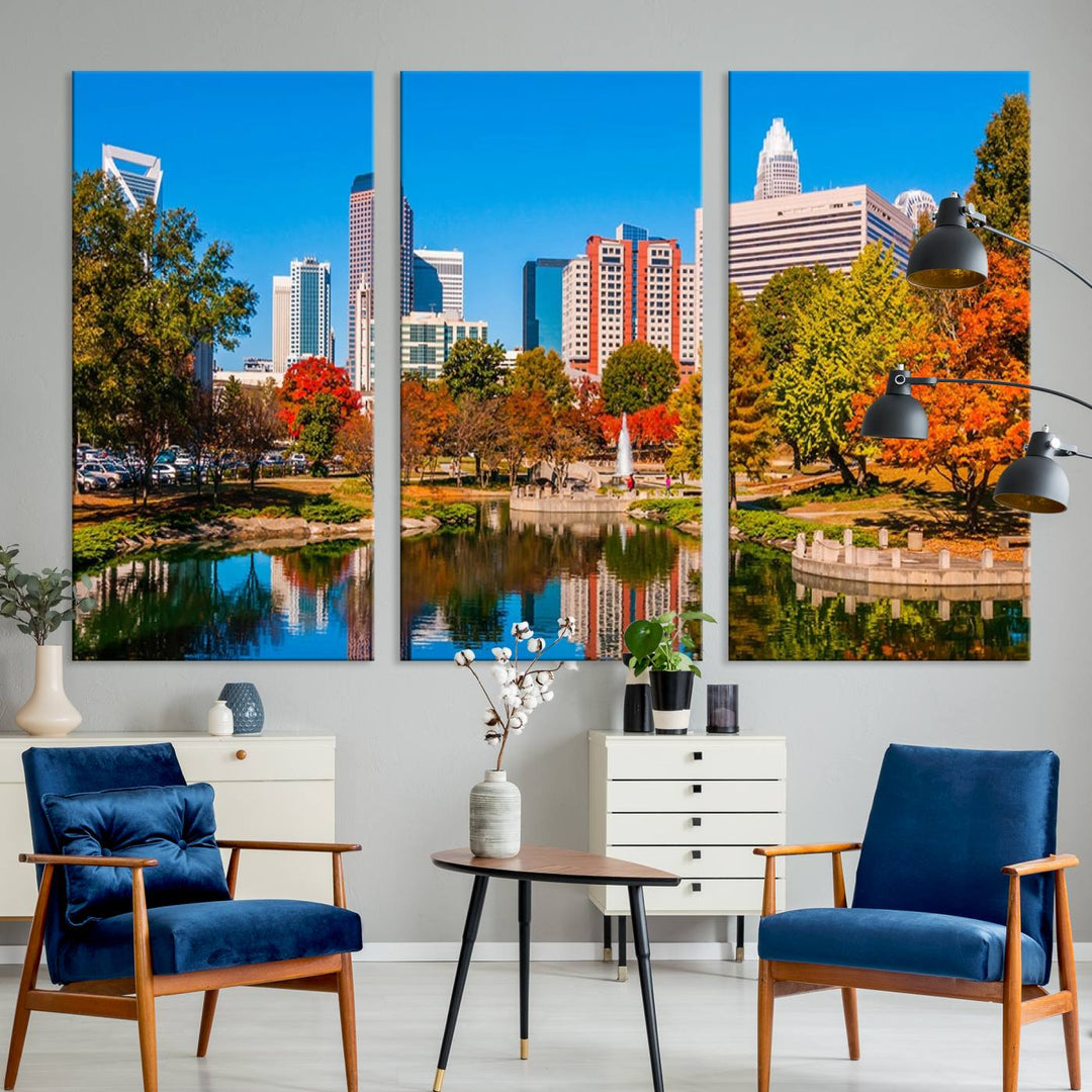 The Charlotte City Park at Fall Skyline Cityscape View wall art canvas print features a city panorama with a park and lake accented by autumn trees. It is mounted on museum-quality canvas with UV-protective coating and decorates the space.