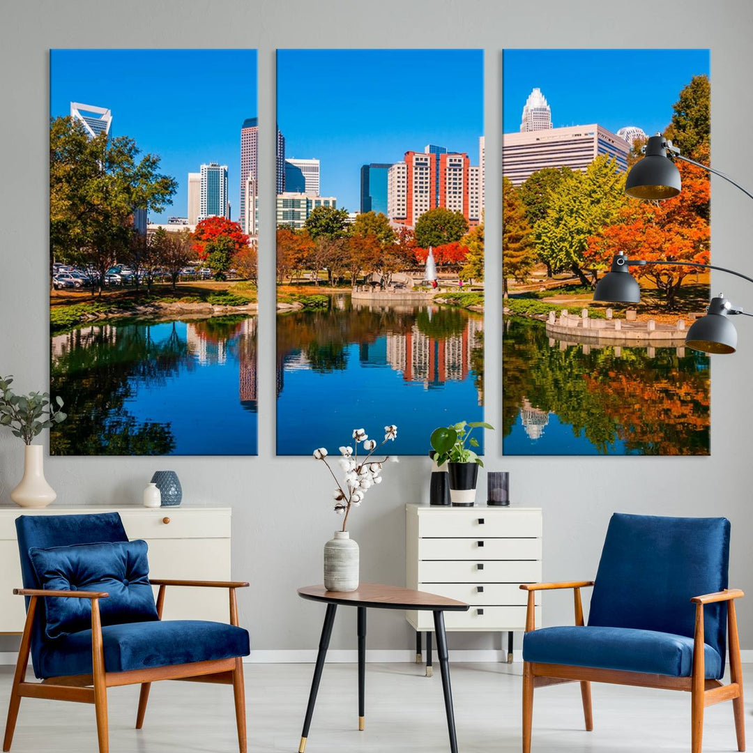 The "Charlotte City Autumn Morning Blue Skyline Cityscape View Wall Art Canvas Print" showcases a cityscape with vibrant autumn trees reflected in a lake. Its gallery-wrapped edges add depth to the scene, while the UV-protective coating ensures lasting brilliance.