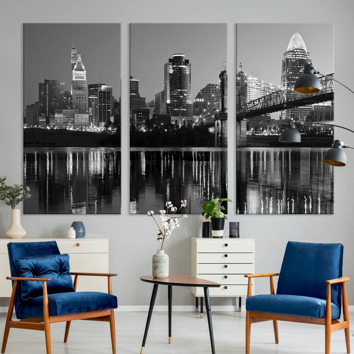 The wall showcases a ready-to-hang triptych of the Cincinnati City Lights Skyline in black and white, printed on museum-quality canvas.