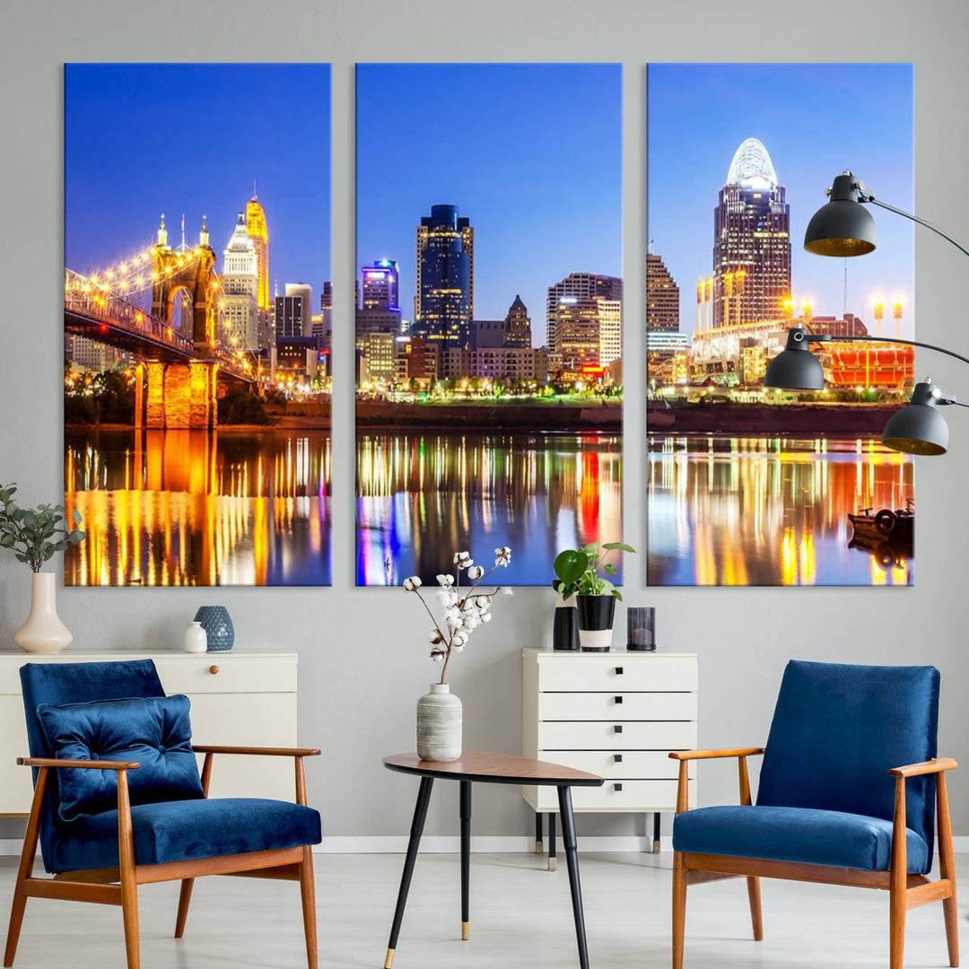 The "Cincinnati City Lights Night Skyline Cityscape View Wall Art Canvas Print" is a gallery-wrapped, museum-quality canvas illustrating a lit-up bridge and skyline at night. Enhanced with a UV-protective coating, this piece ensures lasting vibrancy.