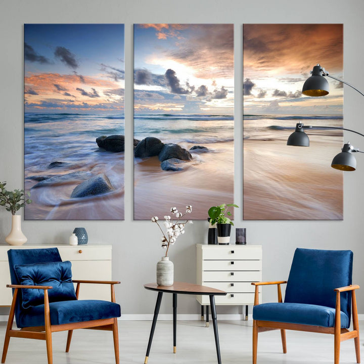 The "Serene Weather On The Beach Wall Art Canvas Print," featuring a tranquil beach scene with rocks and waves, is ready to hang and enjoy.