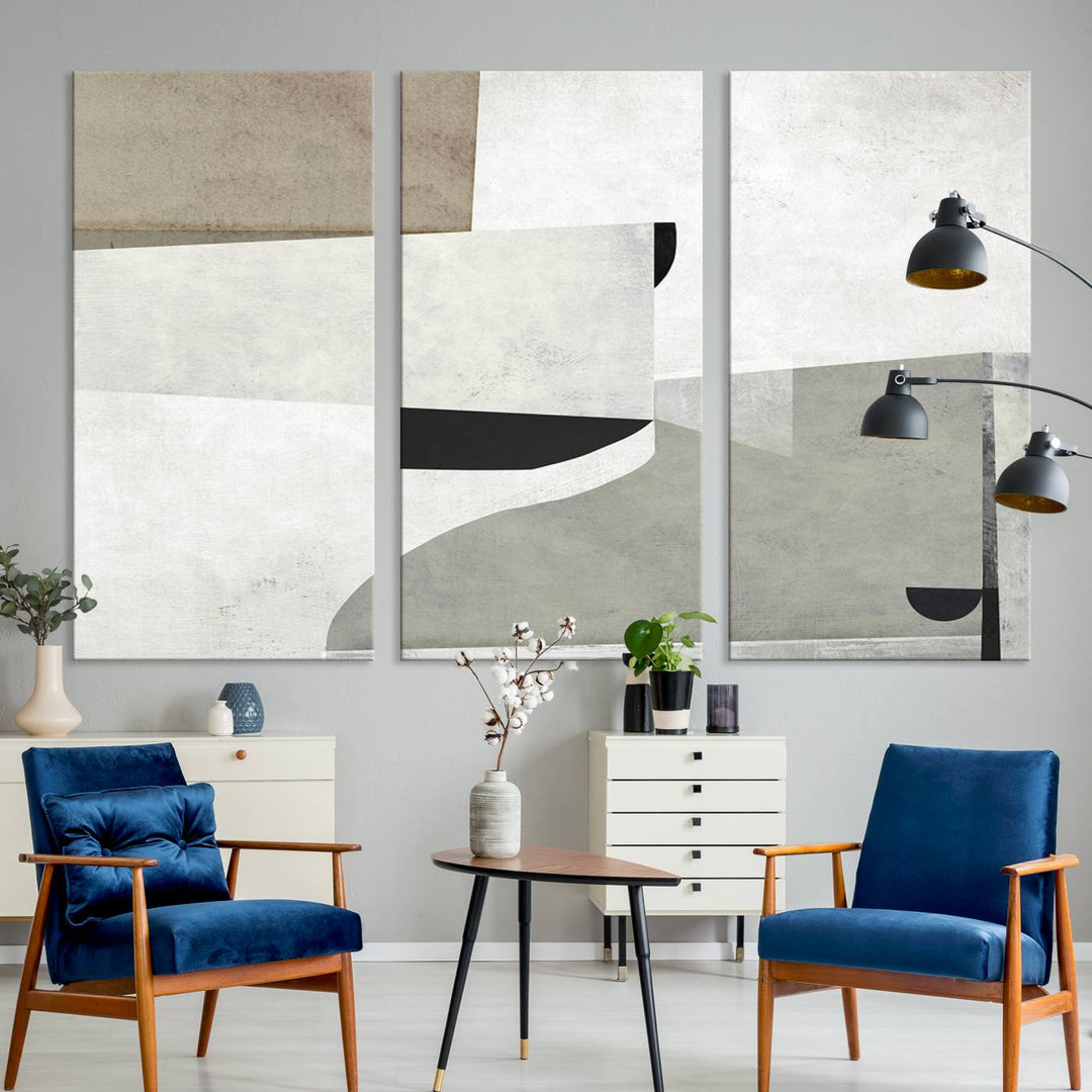 The Brown Gray Figures Abstract Wall Art Canvas Print is displayed as a triptych on a dark wall. The piece is gallery wrapped, offering a seamless finish and enhanced durability due to its UV-protective coating.