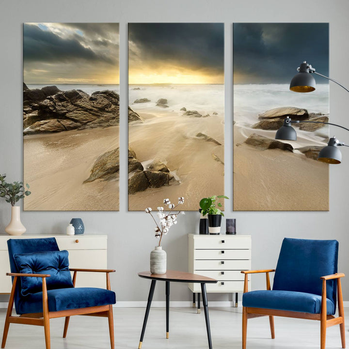 A gallery-wrapped, three-panel artwork titled "Rocks and Waves Wall Art Canvas Print" depicts a rocky beach at sunset. Each canvas showcases museum-quality craftsmanship and a UV-protective coating to maintain its vibrant colors.