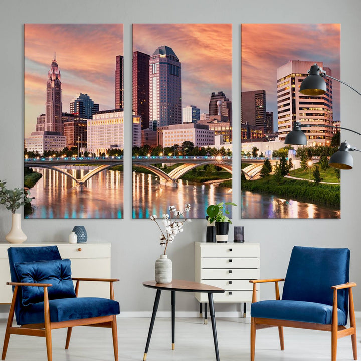 The "Columbus City Lights Sunset Orange Cloudy Skyline Cityscape View" wall art is featured on the wall. This triptych is printed on museum-quality canvas and includes a UV-protective coating, ensuring lasting vibrancy.