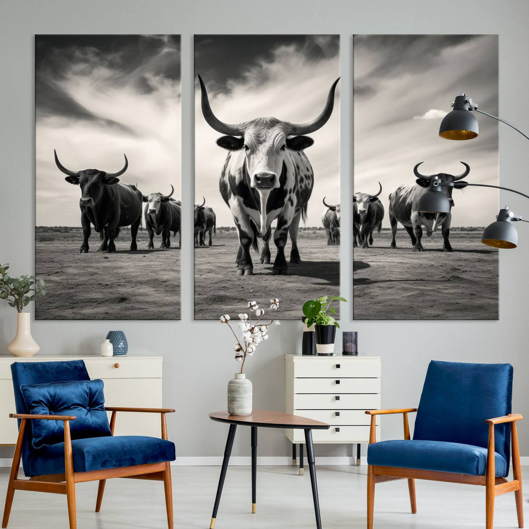 The Black and White Longhorn Cattle Wall Art, featuring a three-panel display of cowboy Western longhorns walking toward the viewer, enhances your space with its striking presence, adding a touch of Western decor.