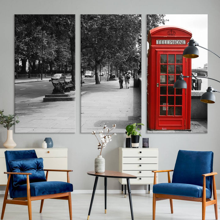 The London Phone Club Wall Art is a stunning piece that showcases a red telephone box set in a black and white street scene on museum-quality canvas. It is gallery wrapped with a UV-protective coating to preserve its vibrant charm.