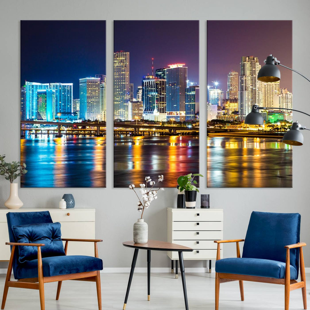 The Wall Art MIAMI Canvas Print features a stunning triptych of a city skyline at night, with vibrant lights reflecting on the water. This gallery-wrapped piece on museum-quality canvas delivers an exquisite finish.