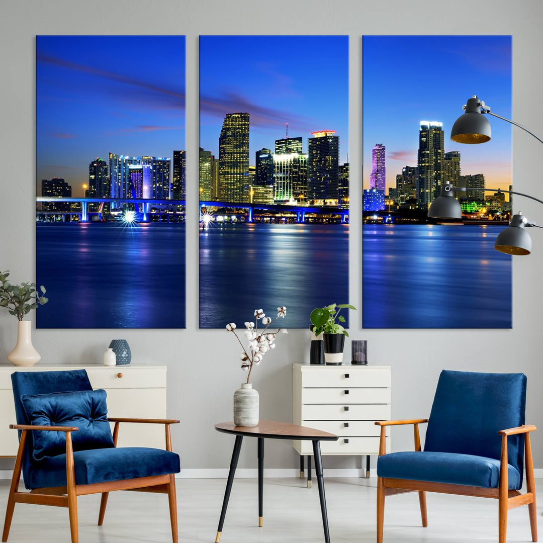 The modern living room showcases a striking Miami Blue Night Wall Art canvas print on the wall. The artwork is gallery wrapped on museum-quality canvas, ensuring durability and elegance.