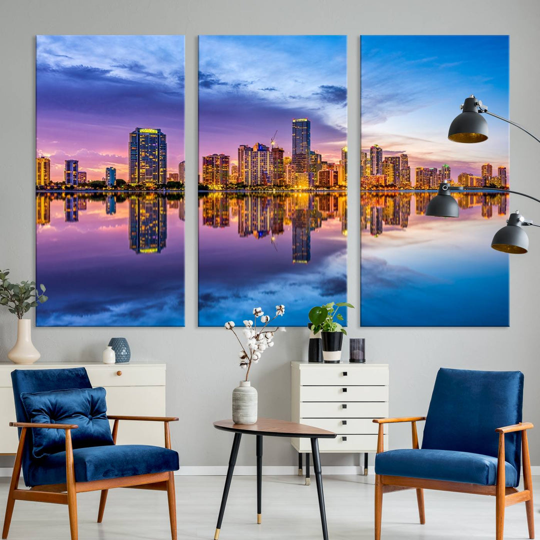 The Miami City Wall Art Canvas Print, featuring a three-panel depiction of a city skyline at sunset reflected in water, beautifully enhances the wall. Made with museum-quality canvas and a UV-protective coating, it comes ready to hang.