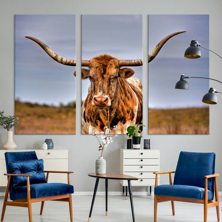 The Texas Longhorn Wall Art Print, a triptych canvas artwork depicting a longhorn bull in a field, features a gallery-quality finish.