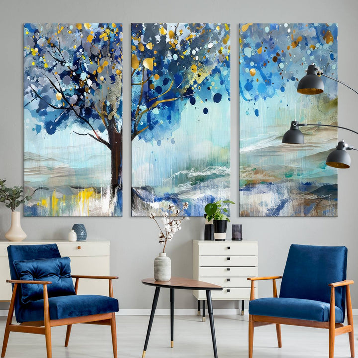 A modern living room features a three-panel Watercolor Style Abstract Tree Printing Wall Art Canvas in vibrant blue and yellow, crafted on museum-quality material.