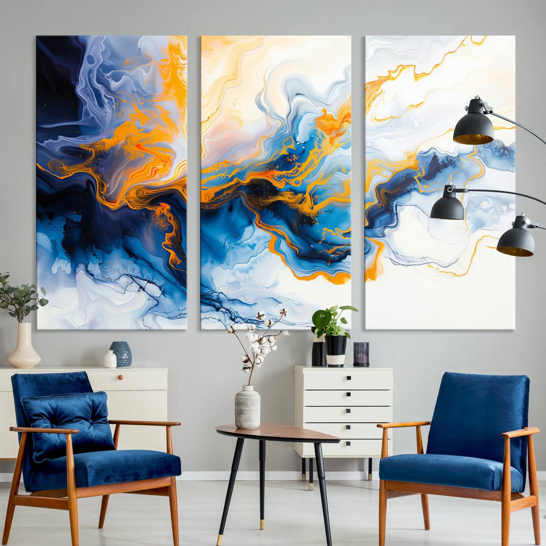 A stunning Fluid Alcohol Ink Wall Art with Gold Wall Art Canvas Print, featuring vibrant blue, orange, and white swirls, adorns the wall. This gallery-quality finish adds an exquisite touch to any living space.