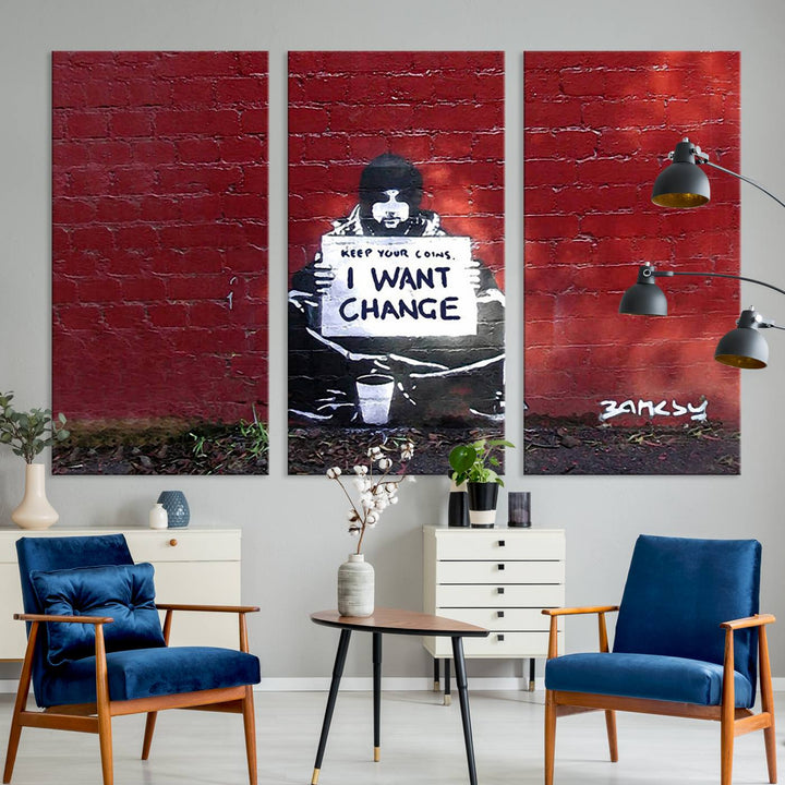 The living room showcases a triptych of stencil artwork on museum-quality canvas, featuring the Banksy I Want Change Graffiti Abstract Wall Art Canvas Print. This captivating piece depicts a person holding a sign that says "I want change" and is finished with a UV-protective coating to ensure long-lasting beauty.