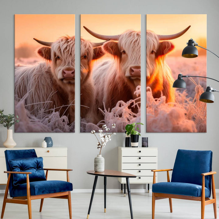 The "Highland Cows at Sunrise Wall Art Canvas Set" beautifully captures a serene and rustic farmhouse aesthetic, portraying two Highland cows in a frosty landscape at sunrise.