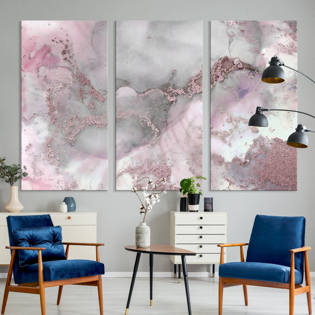 The Rose Marble Abstract Wall Art Canvas Print is a stunning triptych that showcases pink and gray tones, elegantly presented on a dark wall.