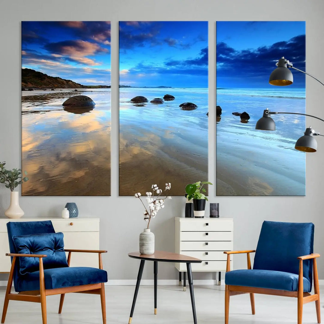 An elegant triptych artwork titled "Wonderful Beach Landscape with Mountain," beautifully displayed on museum-quality canvas, enhances the stylish living room.