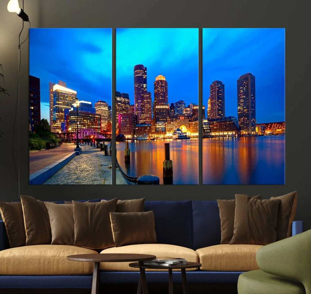 A triptych of the "Boston City Lights Night Blue Skyline Cityscape View Wall Art Canvas Print" adorns the wall. This museum-quality canvas artwork is ready to hang and includes a UV-protective coating for lasting brilliance.