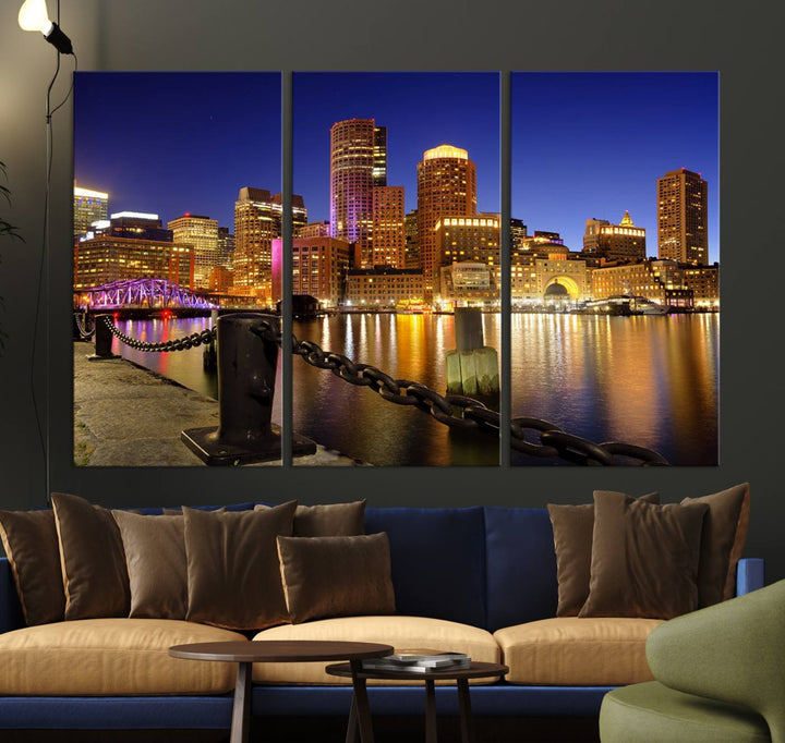 The "Boston City Night Skyline Cityscape View Wall Art Canvas Print" beautifully portrays a stunning triptych of a city skyline illuminated against the night sky, elegantly reflected in the river below. These museum-quality canvases are gallery wrapped to ensure an elegant presentation that enhances any space.