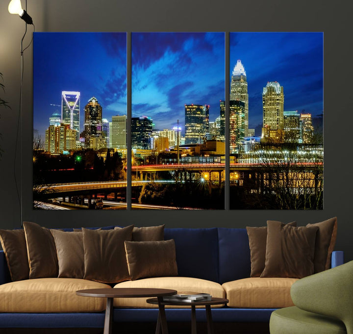 A modern living room highlighted by the "Charlotte City Lights Cloudy Blue Night Skyline Cityscape View" wall art canvas print, crafted on museum-quality canvas with UV-protective coating.